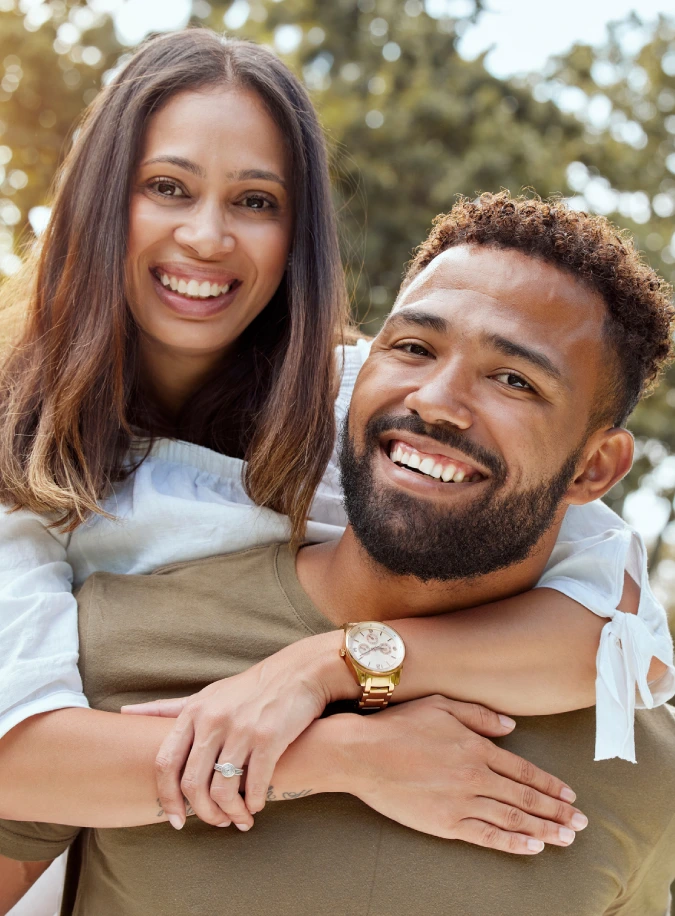 A couple smiling after received dental treatments in Austin