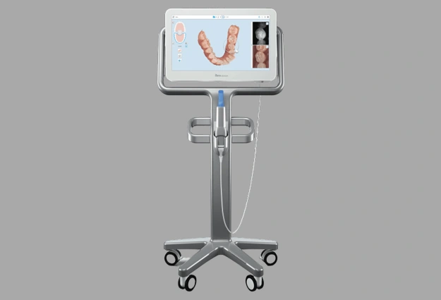 Dental intraoral camera mounted on wheeled stand displaying teeth scan on screen.